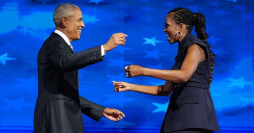 Former President Barack Obama, left, greets former first lady Michelle Obama as he arrives to speak on stage during the Democratic National Convention in a photo dated Aug. 20, 2024.