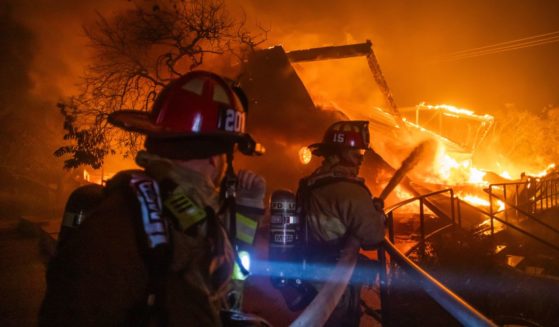 Firefighters fight the flames from the Palisades Fire burning in the Pacific Palisades neighborhood of Los Angeles, California, on Wednesday.