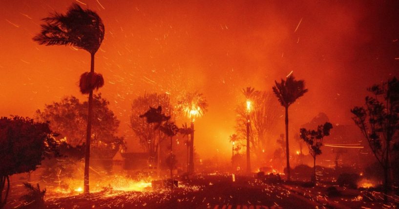 The Palisades Fire ravages a neighborhood amid high winds in the Pacific Palisades neighborhood of Los Angeles Tuesday.