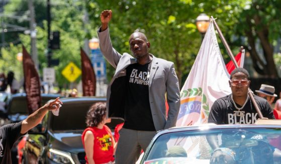 Khalid Kamau, Mayor of South Fulton, Georgia, raises his fist while participating in the Juneteenth Atlanta Black History parade on June 18, 2022 in Atlanta, Georgia. Juneteenth, or Emancipation Day, commemorates the end of chattel slavery on June 19, 1865 in Galveston, Texas, in compliance with President Lincoln's 1863 Emancipation Proclamation.