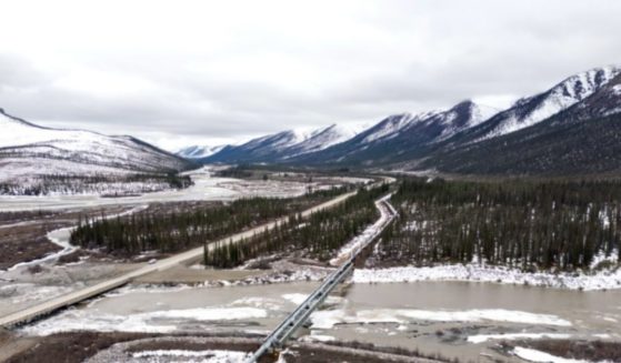 An aerial view of the Dalton Highway and Trans-Alaska Pipeline crossing over the Dietrich River on May 10, 2024 about 19 miles northeast of Wiseman, Alaska.