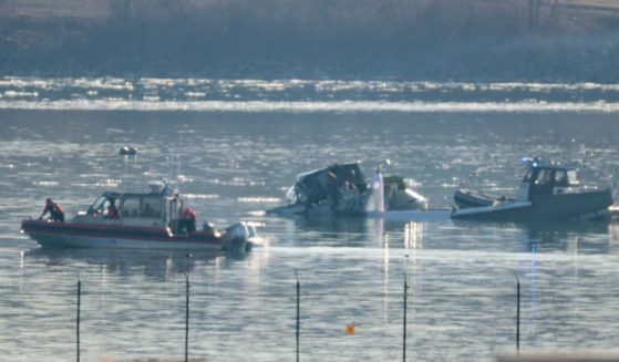 Emergency response units search the crash site of an American Airlines plane and U.S. Army Black Hawk helicopter on the Potomac River on Thursday.