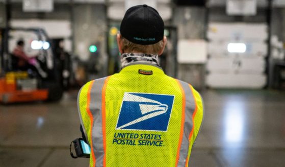 Jim Slowikowski oversees the unloading of pallets filled with Washington and Oregon mail-in ballots at a U.S. Postal Service processing and distribution center in Portland, Oregon, on Oct. 14, 2020.