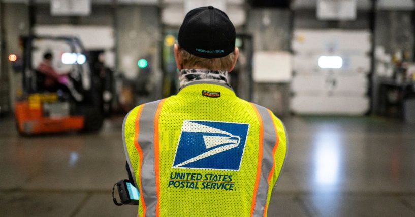 Jim Slowikowski oversees the unloading of pallets filled with Washington and Oregon mail-in ballots at a U.S. Postal Service processing and distribution center in Portland, Oregon, on Oct. 14, 2020.