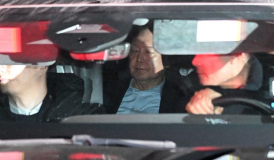 South Korea President Yoon Suk Yeol, center, leaves the complex building housing the Corruption Investigation Office for High-ranking Officials in Gwacheon, South Korea, on Wednesday.