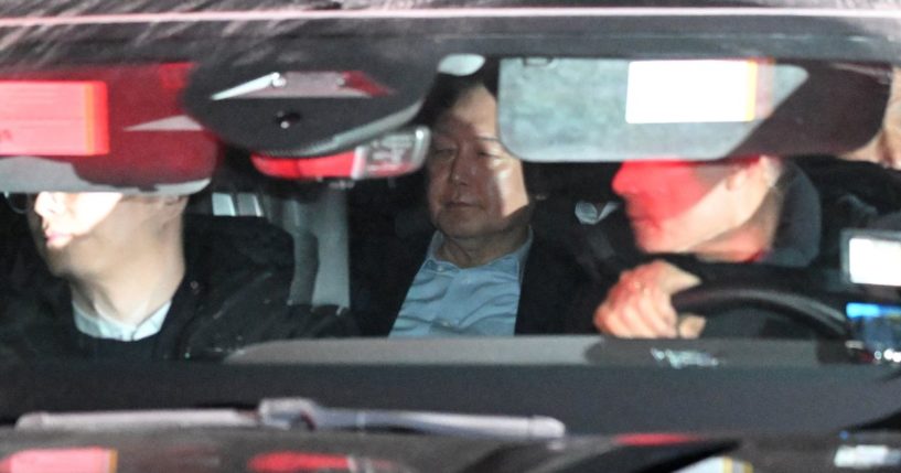 South Korea President Yoon Suk Yeol, center, leaves the complex building housing the Corruption Investigation Office for High-ranking Officials in Gwacheon, South Korea, on Wednesday.