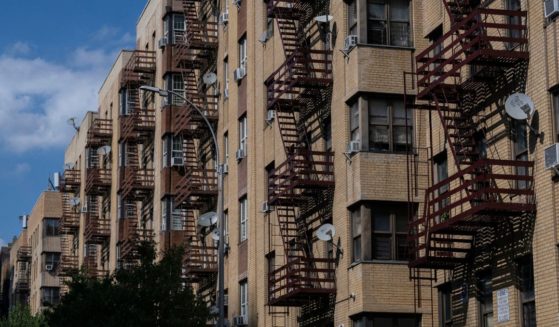 Air conditioning units hang on the windows of a housing project during a summer heat wave in the Bronx borough of New York on July 11, 2024.