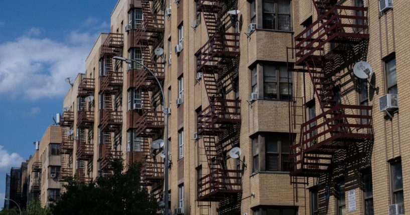 Air conditioning units hang on the windows of a housing project during a summer heat wave in the Bronx borough of New York on July 11, 2024.