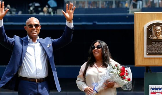 National Baseball Hall of Fame inductee and former New York Yankee Mariano Rivera acknowledges the crowd as he stands with his wife Clara next to his Hall of Fame plaque during a ceremony in his honor at New York City's Yankee Stadium in a photo dated Aug.17, 2019.