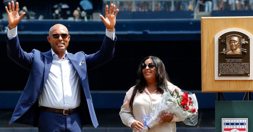 National Baseball Hall of Fame inductee and former New York Yankee Mariano Rivera acknowledges the crowd as he stands with his wife Clara next to his Hall of Fame plaque during a ceremony in his honor at New York City's Yankee Stadium in a photo dated Aug.17, 2019.