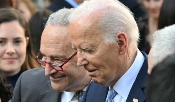 Then-Senate Majority Leader Chuck Schumer, left, and President Joe Biden, right, greet guests during a celebration for Jewish American Heritage Month at the Rose Garden of the White House in Washington, D.C., on May 20.