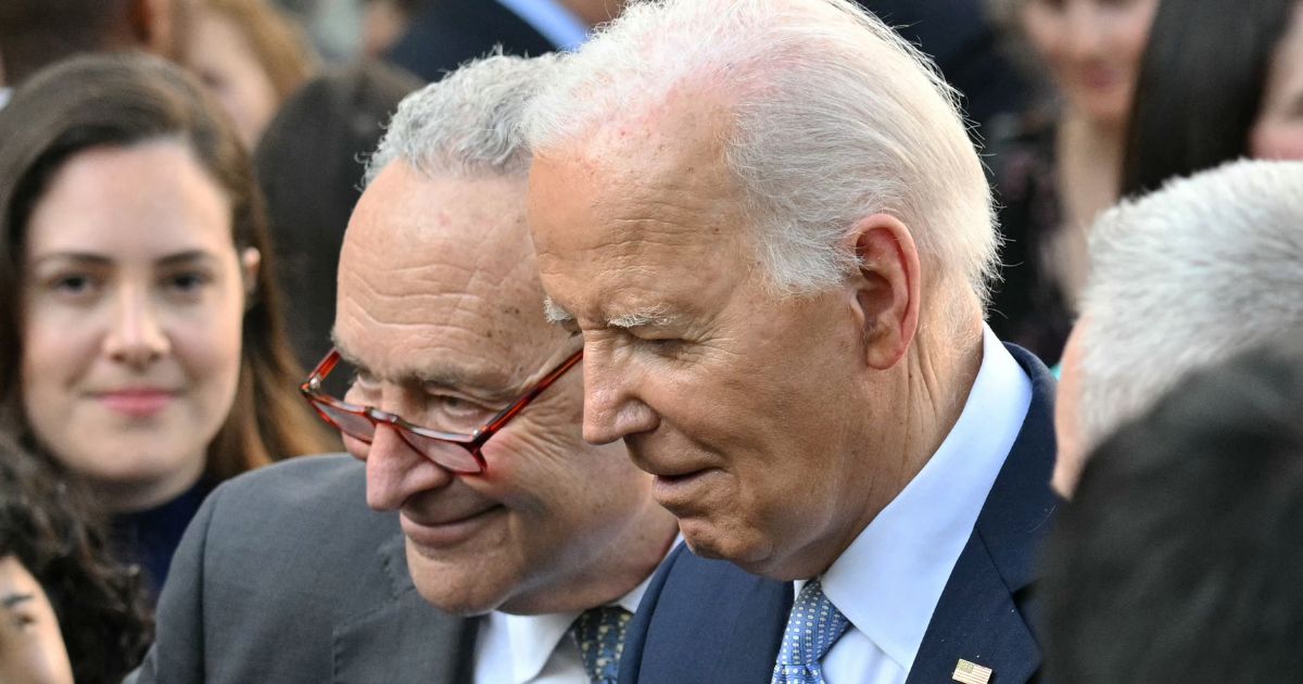 Then-Senate Majority Leader Chuck Schumer, left, and President Joe Biden, right, greet guests during a celebration for Jewish American Heritage Month at the Rose Garden of the White House in Washington, D.C., on May 20.