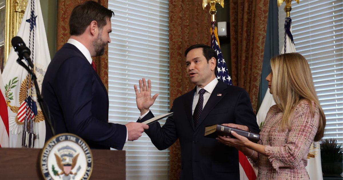 Vice President J.D. Vance, left, swears in Marco Rubio, center, as the secretary of State for the new Trump administration as Rubio's wife Jeanette Dousdebes Rubio, right,looks on at Eisenhower Executive Office Building in Washington, D.C., on Tuesday.