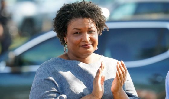 Former Georgia House Rep. Stacey Abrams applauds comments by former President Bill Clinton during the Fort Valley GOTV Community Fish Fry at the Agricultural Technology Conference Center on Oct. 13 in Fort Valley, Georgia.