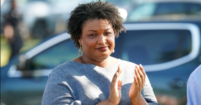 Former Georgia House Rep. Stacey Abrams applauds comments by former President Bill Clinton during the Fort Valley GOTV Community Fish Fry at the Agricultural Technology Conference Center on Oct. 13 in Fort Valley, Georgia.