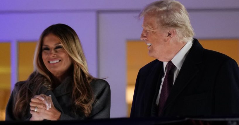 Former and future first lady Melania Trump, left, and President-elect Donald Trump, right, watch a firework display from the Trump National Golf Club in Sterling, Virginia, on Saturday.