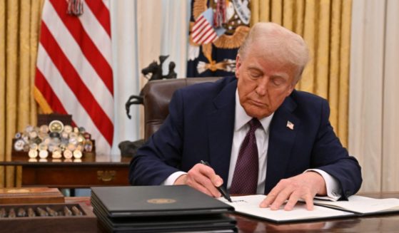 President Donald Trump signs an executive order in the Oval Office of the White House in Washington, D.C., on January 23, 2025.