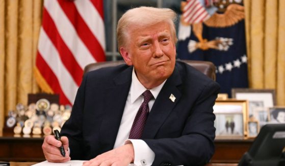 President Donald Trump signs executive orders in the Oval Office of the White House in Washington, D.C., on January 20, 2025.