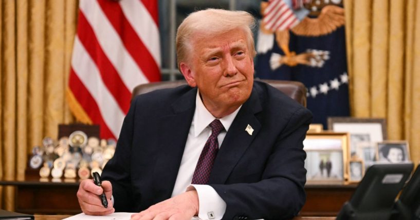 President Donald Trump signs executive orders in the Oval Office of the White House in Washington, D.C., on January 20, 2025.