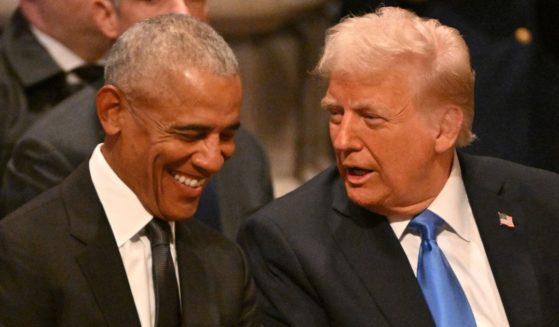 Former President Barack Obama, left, and President-elect Donald Trump, right, speak before the funeral service for former President Jimmy Carter in Washington, D.C., on Thursday.