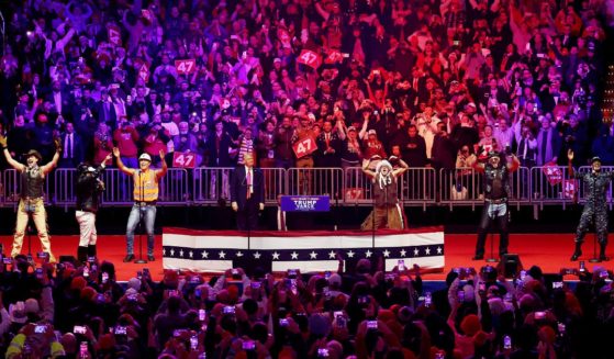 President-Elect Donald Trump watches the Village People perform "YMCA" on stage at his victory rally at the Capital One Arena in Washington, D.C., on Sunday.