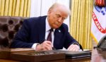 President Donald Trump signs a series of executive orders in the Oval Office of the White House.