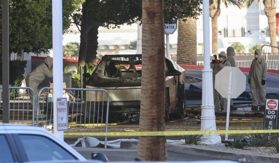 Investigators photograph a Tesla Cybertruck that exploded outside the lobby of President-elect Donald Trump's hotel in Las Vegas, Nevada, on Wednesday.