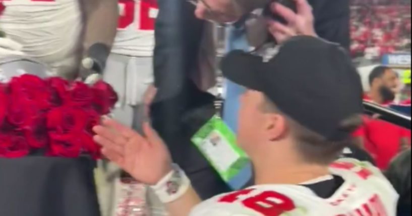 Ohio State Buckeyes quarterback Will Howard speaks to an event worker following the Rose Bowl after he was kept from celebrating with his teammates on stage.