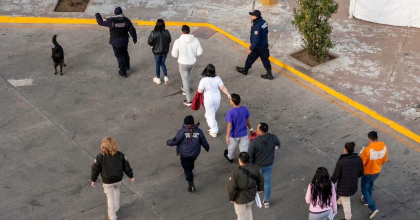 In this aerial view, Mexican immigration officials and police escort deportees after they were sent back into Mexico on January 22, 2025 as seen from Nogales, Arizona.