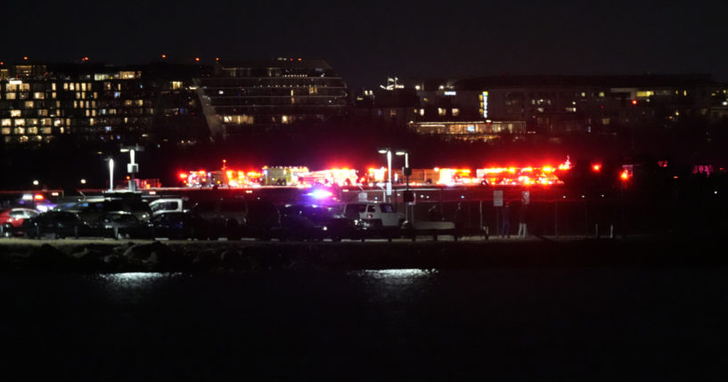 An emergency response team searches the Potomac River south of Ronald Reagan Washington National Airport on Wednesday night after a jet and an Army helicopter crashed.