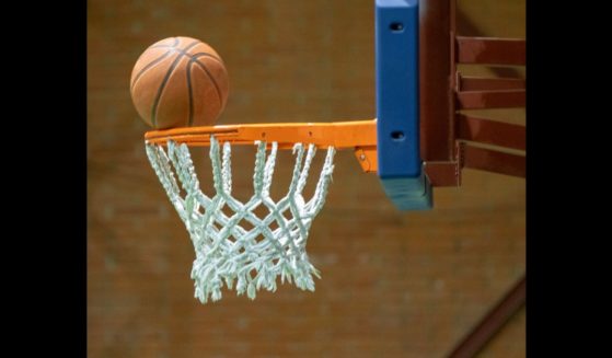 This Getty stock image shows a basketball resting on a hoop.