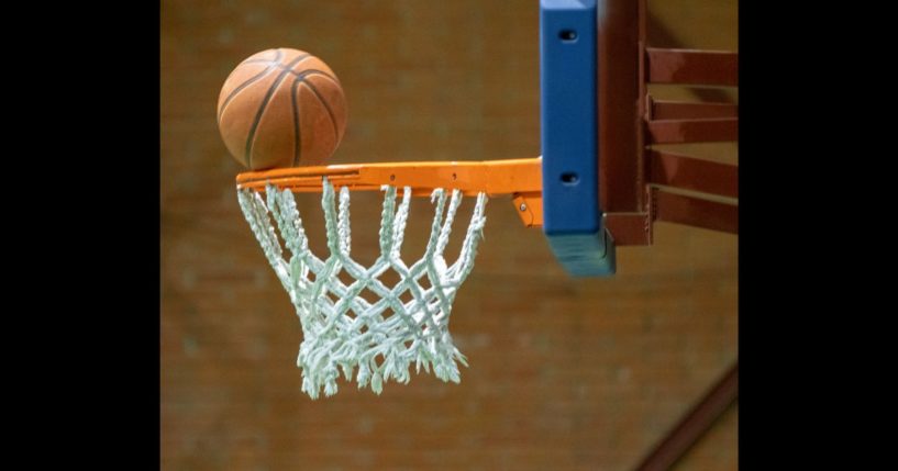 This Getty stock image shows a basketball resting on a hoop.