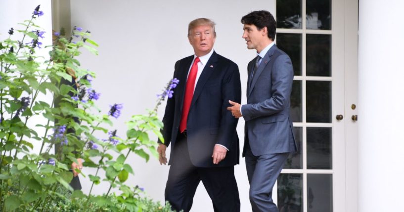 US President Donald Trump (L) listens to Canadian Prime Minister Justin Trudeau as they walk towards the Oval Office of the White House in Washington, DC, on October 11, 2017.