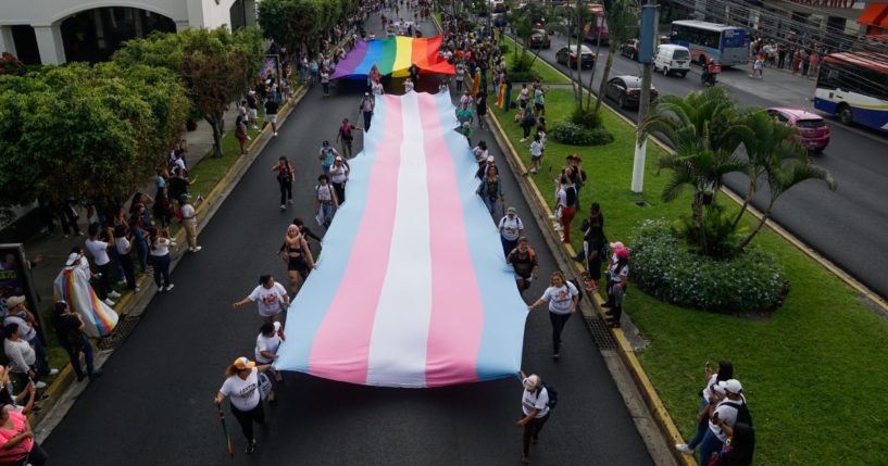 People carry Transgender and Gay Pride flags at a demonstration as part of the LGBTQIA+ pride parade on June 24, 2023 in San Salvador, El Salvador.