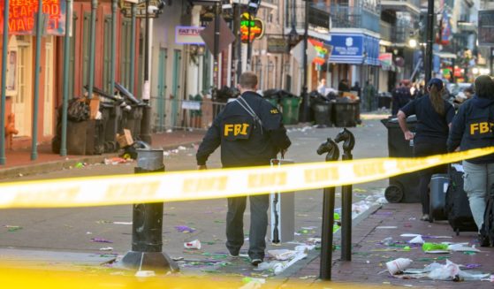 FBI investigators arrive at the scene where the white Ford F-150 pickup truck that crashed into a work lift after allegedly driving into a crowd of New Year's revelers in the French Quarter of New Orleans, Louisiana, on January 1, 2025. At least 10 people were killed and 30 injured Wednesday when a vehicle plowed overnight into a New year's crowd in the heart of the thriving New Orleans tourist district, authorities in the southern US city said.