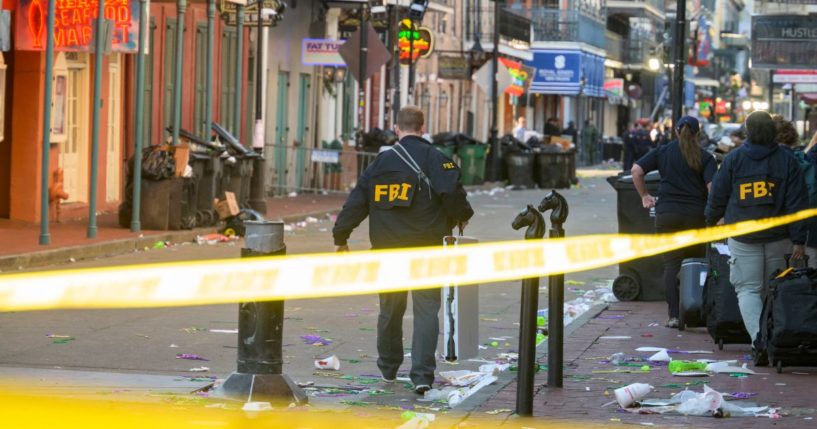 FBI investigators arrive at the scene where the white Ford F-150 pickup truck that crashed into a work lift after allegedly driving into a crowd of New Year's revelers in the French Quarter of New Orleans, Louisiana, on January 1, 2025. At least 10 people were killed and 30 injured Wednesday when a vehicle plowed overnight into a New year's crowd in the heart of the thriving New Orleans tourist district, authorities in the southern US city said.