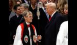 Bishop Mariann Edgar Budde (L) arrives as U.S. President Donald Trump looks on during the National Prayer Service at Washington National Cathedral on January 21, 2025 in Washington, DC.