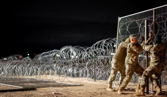 Texas National Guard soldiers install border fencing layered with concertina wire near the Rio Grande river on April 2, 2024 in El Paso, Texas.