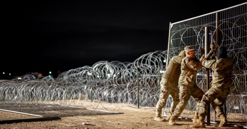 Texas National Guard soldiers install border fencing layered with concertina wire near the Rio Grande river on April 2, 2024 in El Paso, Texas.