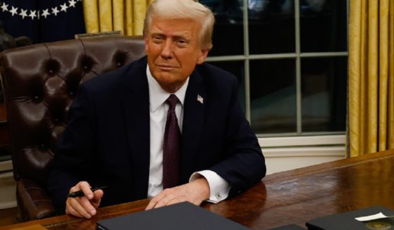 President Donald Trump is pictured signing a flurry of executive orders in the White House Oval Office on Jan. 20.