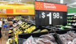 Shoppers search for fruit and vegetable product inside Walmart store, June 1, 2012 in Rosemead, California.