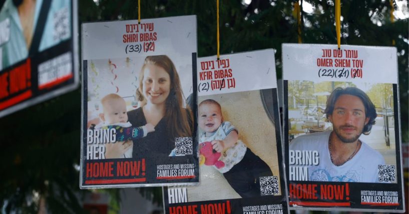 A poster of hostages Shiri Bibas, Kfir Bibas, and Omer Shem Tov are displayed in hostages square prior the handover of four bodies taken by Hamas fighters on Feb. 20, 2025, in Tel Aviv, Israel.