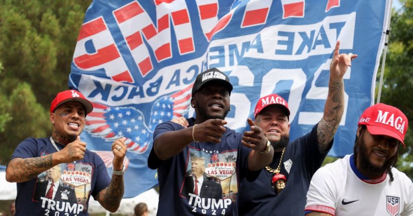 A man who calls himself "The Black Donald Trump," second from left, and rapper Forgiato Blow, second from right, perform during a campaign rally for then-Republican presidential candidate Donald Trump at Sunset Park in Las Vegas, Nevada on June 9.