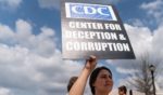 People are seen at a protest against masks, vaccines, and vaccine passports outside the headquarters of the Centers for Disease Control headquarters in Atlanta, Georgia, in this file photo from March 13, 2021.