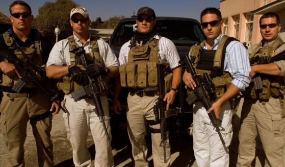 Private security contractors, from left to right, Pat Scott, Mike Stocksett, Neil Gary, Matt Goss, and Kyle Kaszynski pose for a photograph while on a break from providing security in Kabul, Afghanistan, on Nov. 1, 2005.