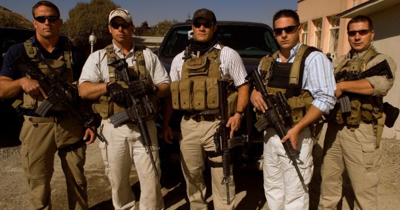 Private security contractors, from left to right, Pat Scott, Mike Stocksett, Neil Gary, Matt Goss, and Kyle Kaszynski pose for a photograph while on a break from providing security in Kabul, Afghanistan, on Nov. 1, 2005.