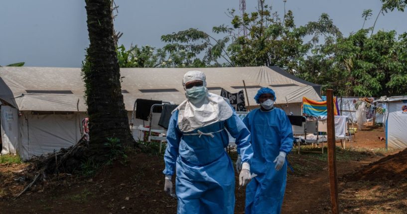 Two workers from the NGO Alima walk in the courtyard of the monkeypox treatment center in Kamituga, South Kivu, in the east of the Democratic Republic of the Congo on Sept. 20, 2024.