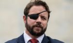 Rep. Dan Crenshaw speaks to the media outside the U.S. Capitol after voting in the House in Washington, D.C., on Sept. 29, 2023.