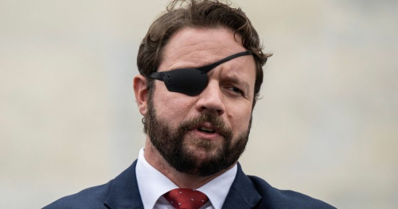 Rep. Dan Crenshaw speaks to the media outside the U.S. Capitol after voting in the House in Washington, D.C., on Sept. 29, 2023.