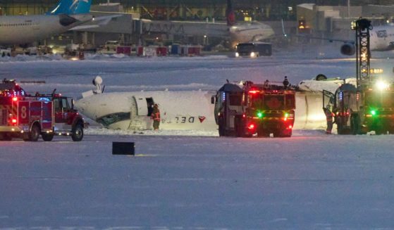 A Delta airlines plane sits on its roof after crashing upon landing at Toronto Pearson Airport in Toronto, Ontario, on Monday.